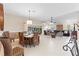 Spacious dining area with a dark wicker dining set with an open layout to the living room at 1716 Bugle Ter, The Villages, FL 32162