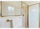 Neutral-toned tiled shower with glass doors and modern fixtures at 1716 Bugle Ter, The Villages, FL 32162