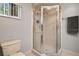 Bathroom featuring a glass enclosed shower, a toilet, and tile flooring at 17806 Se 97Th Ct, Summerfield, FL 34491