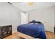 Cozy bedroom features wood floors, ceiling fan, and ample natural light at 17806 Se 97Th Ct, Summerfield, FL 34491