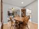 Dining room showcasing hardwood floors and views into both the living room and kitchen at 17806 Se 97Th Ct, Summerfield, FL 34491