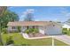 Charming single-story home with well-manicured lawn, garden, and attached two-car garage at 17806 Se 97Th Ct, Summerfield, FL 34491