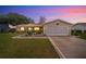 Charming single-story home featuring a manicured lawn and an attached two-car garage at 17806 Se 97Th Ct, Summerfield, FL 34491