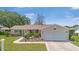 Well-maintained single-story home with a neatly landscaped front yard and a two-car garage at 17806 Se 97Th Ct, Summerfield, FL 34491