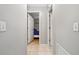 Hallway showing the doors to other rooms and neutral tile flooring at 17806 Se 97Th Ct, Summerfield, FL 34491