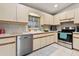 Bright eat-in kitchen features tile flooring, stainless steel appliances and updated cabinets at 17806 Se 97Th Ct, Summerfield, FL 34491