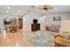 Spacious open-concept living room with hardwood floors adjacent to the dining area and kitchen at 17806 Se 97Th Ct, Summerfield, FL 34491
