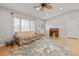 Comfortable living room with hardwood floors, ceiling fan, and front door at 17806 Se 97Th Ct, Summerfield, FL 34491