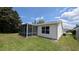 Lanai situated in a large backyard with lawn at 17930 Se 83Rd Melody Ave, The Villages, FL 32162
