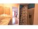 Bathroom featuring a view of the bedroom, marble counter, decorative shower curtain, and ample natural light at 17930 Se 83Rd Melody Ave, The Villages, FL 32162