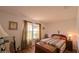 Comfortable bedroom with hardwood floors and natural light from the window at 17930 Se 83Rd Melody Ave, The Villages, FL 32162