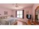 Bedroom with hardwood flooring, neutral walls and ceiling fan at 17930 Se 83Rd Melody Ave, The Villages, FL 32162