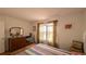 Bedroom featuring hardwood floors, natural light, and a comfortable layout at 17930 Se 83Rd Melody Ave, The Villages, FL 32162