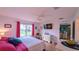 Bright bedroom featuring a view of the patio, wooden floors, and a dresser with mirror at 17930 Se 83Rd Melody Ave, The Villages, FL 32162