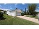 View of a single-story home with a one-car garage, driveway, and landscaping at 17930 Se 83Rd Melody Ave, The Villages, FL 32162