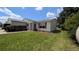 Well-kept single-story home featuring a tidy lawn and tasteful landscaping at 17930 Se 83Rd Melody Ave, The Villages, FL 32162
