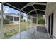 Screened-in lanai featuring outdoor table and chairs, providing a cozy outdoor space at 17930 Se 83Rd Melody Ave, The Villages, FL 32162
