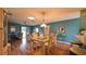 Open concept dining room and living room with beautiful hardwood flooring at 17930 Se 83Rd Melody Ave, The Villages, FL 32162