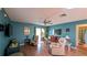 Comfortable living room with ceiling fan and sliding glass door access to backyard at 17930 Se 83Rd Melody Ave, The Villages, FL 32162