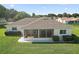 Aerial view of the back of the house featuring a screened lanai and landscaped backyard at 17985 Se 102Nd Ct, Summerfield, FL 34491