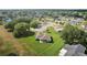 Expansive aerial view of a lovely home showcasing a well-manicured lawn and lush, mature trees in a quiet neighborhood at 17985 Se 102Nd Ct, Summerfield, FL 34491