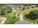 Aerial view of the house showcasing the surrounding landscape, golf course, and neighborhood at 17985 Se 102Nd Ct, Summerfield, FL 34491