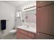 Functional bathroom featuring a white vanity, sink, and a large mirror, providing a clean and practical space at 17985 Se 102Nd Ct, Summerfield, FL 34491