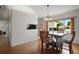 Cozy dining area features a wooden table and chairs with a view of the backyard, ideal for Gathering meals at 17985 Se 102Nd Ct, Summerfield, FL 34491