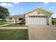 Charming single-story home with a two-car garage, landscaped yard, and a welcoming entrance at 17985 Se 102Nd Ct, Summerfield, FL 34491