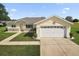 Charming single-story home with a two-car garage, landscaped yard, and a welcoming entrance at 17985 Se 102Nd Ct, Summerfield, FL 34491
