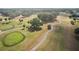 Picturesque aerial view of a well-manicured golf course surrounded by lush greenery at 17985 Se 102Nd Ct, Summerfield, FL 34491