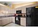 Well-lit kitchen with a microwave and refrigerator offering a clean and efficient cooking space with ample storage at 17985 Se 102Nd Ct, Summerfield, FL 34491