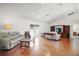 Bright living room features hardwood floors, vaulted ceilings, and large windows at 17985 Se 102Nd Ct, Summerfield, FL 34491