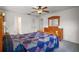 Spacious main bedroom with a wooden dresser, bed, and access to an ensuite bathroom at 17985 Se 102Nd Ct, Summerfield, FL 34491