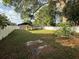 Spacious backyard features a white privacy fence and mature tree at 1805 Ne 29Th Pl, Ocala, FL 34479