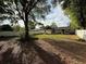 Expansive backyard with mature tree and a white vinyl privacy fence at 1805 Ne 29Th Pl, Ocala, FL 34479
