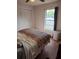 This bedroom features a closet, window, and colorful chevron-patterned blanket at 1805 Ne 29Th Pl, Ocala, FL 34479