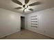The bedroom is equipped with a ceiling fan and built-in shelving at 1805 Ne 29Th Pl, Ocala, FL 34479
