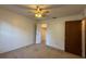 Bright bedroom features a ceiling fan and doorway to the en suite bathroom at 1805 Ne 29Th Pl, Ocala, FL 34479