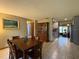 A wood dining table situated near the open-concept kitchen and living areas at 1805 Ne 29Th Pl, Ocala, FL 34479