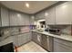 Modern kitchen with granite countertops, gray cabinets, and stainless steel appliances at 1805 Ne 29Th Pl, Ocala, FL 34479