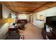 This living room features a wood ceiling and plenty of windows at 1805 Ne 29Th Pl, Ocala, FL 34479