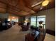 The living room has a wood ceiling and multiple windows for ample light at 1805 Ne 29Th Pl, Ocala, FL 34479