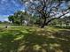 Expansive backyard featuring mature trees and lush green lawn, perfect for outdoor activities at 18130 Keene Rd, Altoona, FL 32702