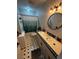 Compact bathroom featuring tile flooring, shower-tub combo with updated fixtures at 18130 Keene Rd, Altoona, FL 32702