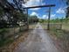 Long private driveway leads to a gated entrance, providing security and seclusion at 18130 Keene Rd, Altoona, FL 32702