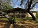 Two-story home featuring a spacious balcony with views of the expansive front yard and mature trees at 18130 Keene Rd, Altoona, FL 32702