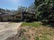 Well-maintained ranch-style home with an attached two-car garage, lush landscaping and mature trees at 18130 Keene Rd, Altoona, FL 32702
