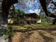Two-story home featuring a balcony with views of the expansive yard and mature trees at 18130 Keene Rd, Altoona, FL 32702