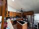 Well-equipped kitchen features wood cabinets, stainless steel appliances, an island, and a modern design at 18130 Keene Rd, Altoona, FL 32702